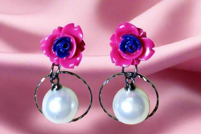 Trendy statement earrings with bold geometric design, fashion-forward jewelry for women. Punnagaidj. Black metal. Classic pearl earrings with black metal setting.must-have jewelry for an elegant look