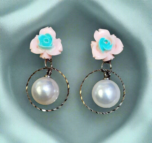 Trendy statement earrings with bold geometric design, fashion-forward jewelry for women. Punnagaidj. Black metal. Classic pearl earrings with black metal setting.must-have jewelry for an elegant look