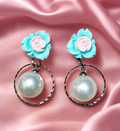 Trendy statement earrings with bold geometric design, fashion-forward jewelry for women. Punnagaidj. Black metal. Classic pearl earrings with black metal setting.must-have jewelry for an elegant look